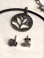 Pendant on cord with earrings close-up