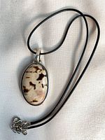 Pendant and cord laid flat showing stone pattern and clasp