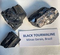 Three black tourmaline pieces with origin tag