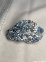 Full view of blue calcite specimen on neutral background