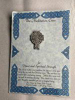 Pin on original display card showing branding and motif