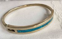 Full view of alpaca silver bracelet showing turquoise inlay and clasp