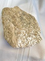 Front view of mica schist specimen showing silvery foliated surface