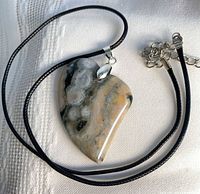 Full view of ocean jasper heart pendant on black cord