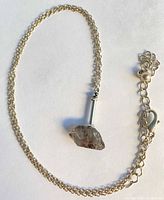 Full view of necklace showing chain, extender and quartz pendant