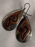 front view of both earrings showing copper inlay swirl design
