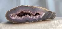 Side profile of geode showing banded agate layers and crystal cavity