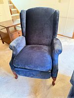 front view of navy blue wingback recliner showing upholstery and seat