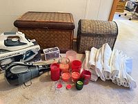 Full lot showing both wicker trunks, Rowenta iron box, vacuum, towels and candles