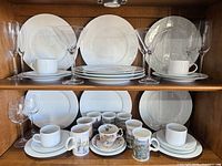Overall view of plates, mugs and stemware on hutch shelves