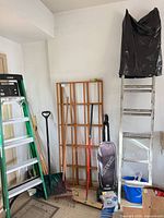 Overall lot with ladders, trellis, tools, vacuum, bucket