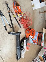 Lot overview showing blower, loppers, extension cord, bag kit
