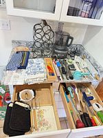 Overview showing Cuisinart processor, wine rack, utensils in drawers, linens