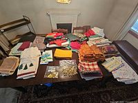 Full lot of folded linens and small décor items spread on dining table