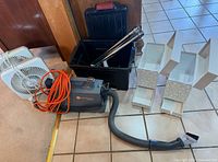 Group shot showing vacuum, hose, wands in tote, floor tool, two box fans and decorative boxes