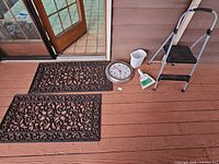 Lot overview showing both doormats, clock, dustpan set, waste bin and step stool