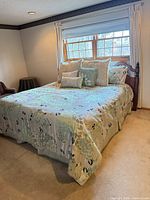Full view of bed with comforter, pillows, headboard