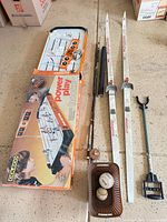 All items laid out: Coleco hockey board with box, three fishing rods, softball, baseball, retrieval tool, pair of Madshus skis