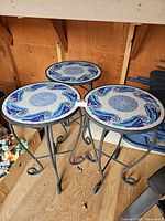 Top view showing three tables with blue/white mosaic tile tops