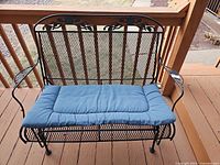 Front view of bench with blue cushion in place