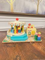 Overall view of carousel, ticket booth and figures