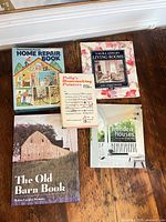 All five books laid out on floor showing covers