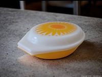 Covered casserole showing sunflower lid and yellow base