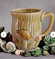 Handled mug showing bark texture and raised mushrooms
