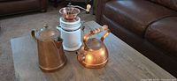 Overall view of kettle, coffee pot and grinder on table