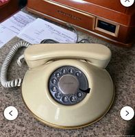 Telephone base with handset on countertop