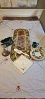 Full lot on tablecloth showing linens and all serveware items