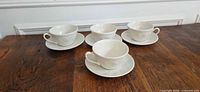 Four cups each on its saucer displayed on table