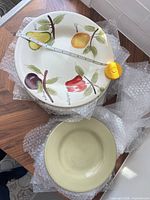 Stack showing dinner plate with tape measure and salad plate
