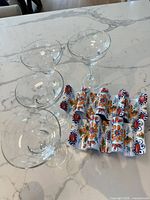 Overview of four margarita glasses and four melamine taco holders on countertop