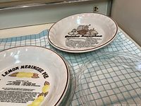Ceramic recipe pie plates and glass pie plate on towel