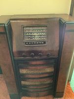 Front view of Crosley floor console radio showing dial, knobs, pushbuttons and speaker grille