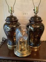 Front view of two ceramic lamps and anniversary clock