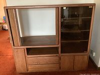 Front view of oak cabinet showing glass doors, shelves, drawers and lower doors