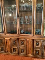 Front view showing full cabinet with upper glass display and lower storage