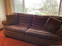 Two-seat Sklar Peppler sofa with striped upholstery, cushions and pillow