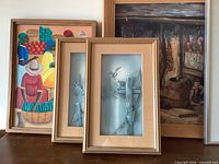 Group shot showing colorful still life, two seagull prints, and cabin interior painting
