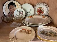 All assorted ceramic plates, bowls and glass cups arranged on shelf