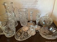 Group image showing all eight crystal pieces including pitchers, vase, candlesticks, covered dish, tray and bowl