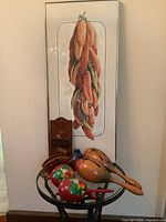 Group shot showing framed chili pepper print, metal table and all decorative items