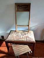 All three items together: washboard resting on stool, collapsible stand folded beneath