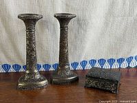 Front view of both candlesticks and trinket box showing overall design and patina.