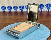 Compact open showing mirror and powder compartment