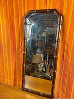 Full view of mirror showing faux bamboo frame and glass