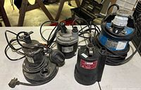 Four submersible pumps on table