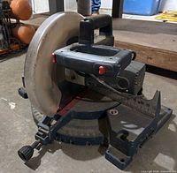 Left side view of Bosch 10 in compound miter saw showing handle, blade guard and miter scale